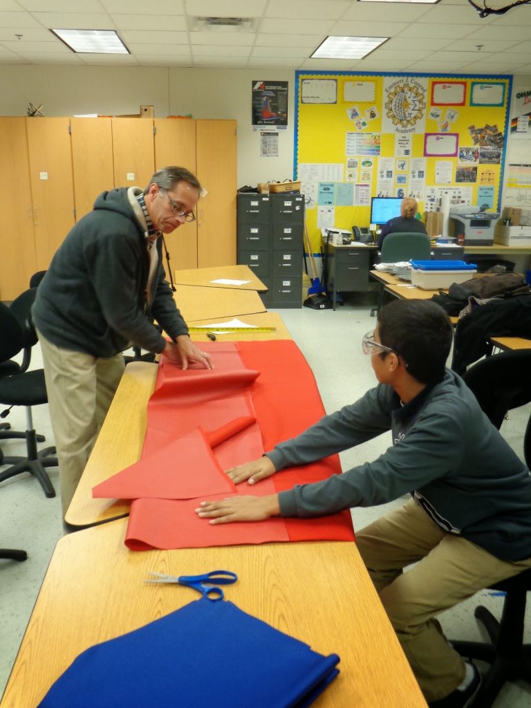 Mentor Tim Bauer and student Ivan G. cutting fabric for our bumper