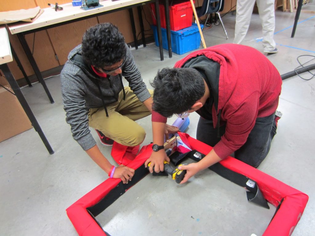 Students Ghana B. and Arturo D. begin disassembling the old bumper