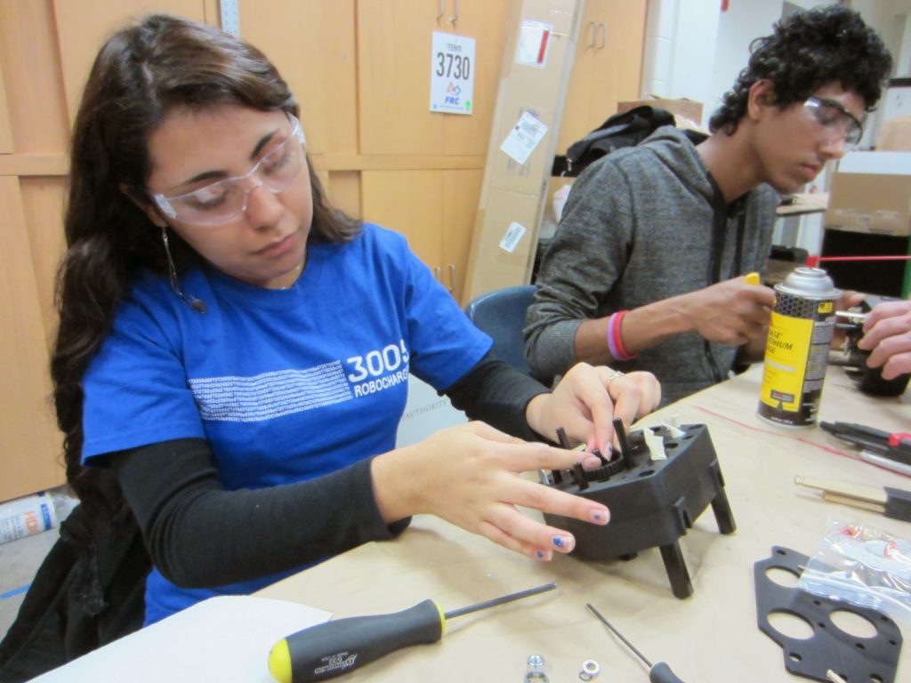 Students Azucena M. and Gana B. work on the gear boxes