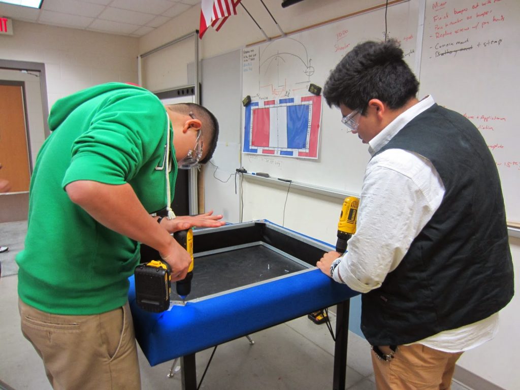 Students Oscar G. and Arturo D. do some quick modifications to our bumpers